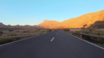 A road in the desert with mountains in the background photo