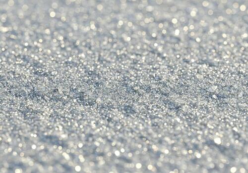 Closeup macro view of frost crystals on a surface, sparkling in the light, isolated on white background photo