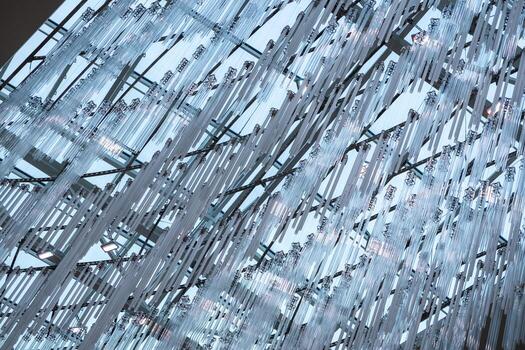 Modern architectural ceiling adorned with numerous hanging transparent and fluorescent light tubes, forming an abstract and futuristic pattern, symbolizing innovative design and energy efficiency photo