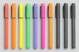 A vibrant selection of markers in various colors arranged neatly in a row. The bright hues include yellow, green, orange, purple, and black, showcasing their suitability for creative projects. photo