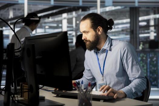 System administrator in data center doing software updates, verifying neural network parameters. Server hub IT expert using PC to inspect configurations, ensuring optimal application performance photo