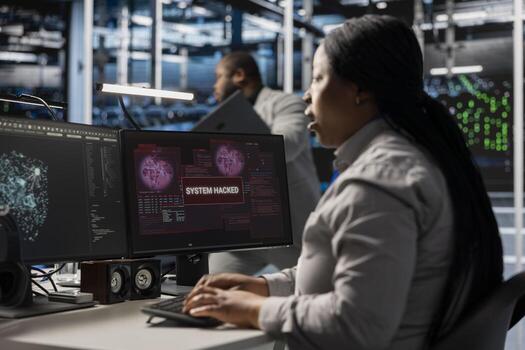 Server farm IT specialist trying to repair compromised hardware after hacker attack. Software developer in data center fighting malicious threat, initiating protocol to protect critical systems photo