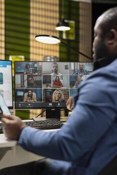African american man attending a meeting on remote call, discussing with business partners about a new collaboration to expand the company internationally. Web chat event. photo