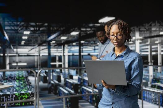 Data center female system administrator performing maintenance with AI for automation. Engineering specialist managing data infrastructure used for machine learning in server hub. photo