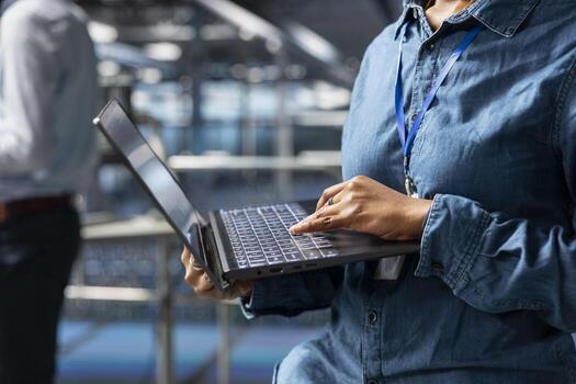 Server farm engineer managing storage arrays supporting machine learning for system management workflow. Technician on industrial platform handling AI processing tasks, programming. photo