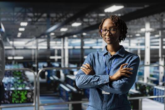 Portrait of african american engineer ensuring server hub automation, reviewing AI LLM visualizations in data center. IT professional analyze neural network systems for infrastructure. photo