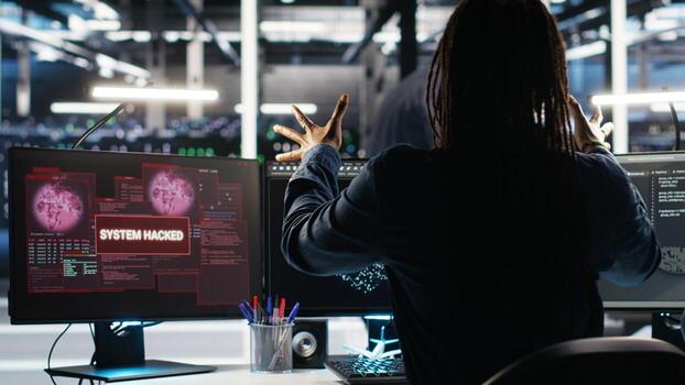 Panicked engineer in AI server facility reacts to hacking incident involving theft of sensitive data. Data center employee alarmed by computer virus triggered by security systems, camera B photo