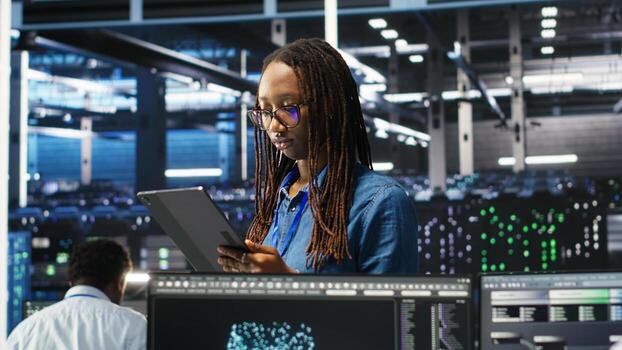 Server farm engineering team using AI algorithms and node tree systems to categorize unstructured data. Data center IT experts use visual programming and natural language processing software, camera B photo