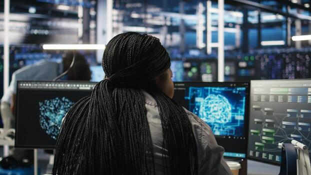 Data center staff member in office using AI deep learning algorithms to analyze datasets. African american woman in server room using artificial intelligence neural networks, camera A photo