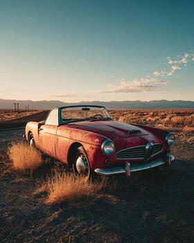 Lone vintage convertible with faded paint parked on empty desert road surrounded by dry grass captured in cinematic atmospheric lighting photo