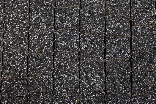 Textured pavement blocks arranged in a grid pattern on a walkway photo