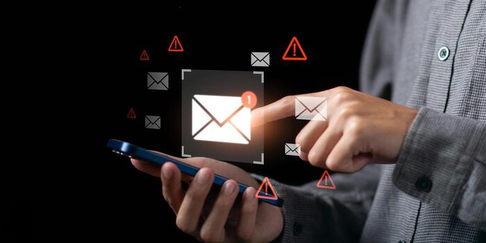Email notification alert with warning signs, showing cybersecurity threats and phishing risks on mobile device interface. Concept of digital communication vulnerability and online scam protection. photo