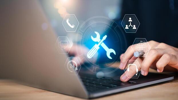 IT support and digital tools concept. Person using laptop with glowing wrench and screwdriver , representing system maintenance, tech service, customer support, and online troubleshooting in business photo