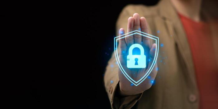 Cybersecurity concept with person holding glowing digital padlock shield icon, symbolizing data protection, privacy, secure access, online safety, ideal for IT, digital business, internet security photo