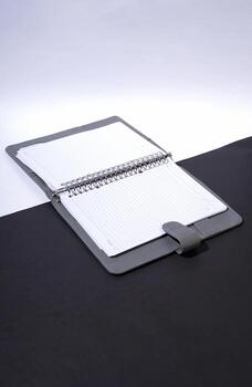 Open Notebook with Spiral Binding on a Split Black and White Background photo