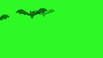 un bucle 2d animación de dibujos animados murciélago siluetas con rojo ojos volador a través de un sólido verde antecedentes. múltiple murciélagos moverse en un continuo, sin costura modelo. video