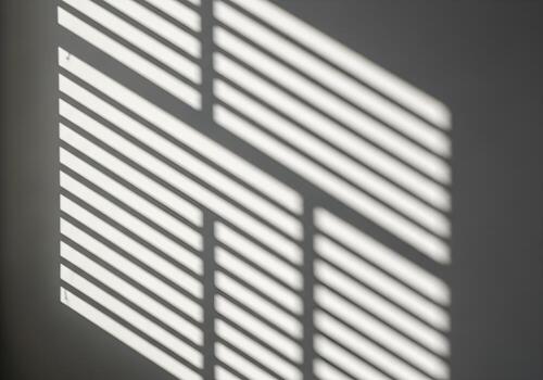 Geometric sunlight shadows on white wall creating high-resolution abstract background image with sharp edges, no people or objects in the frame photo