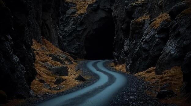 A dark tunnel with a road going through it photo