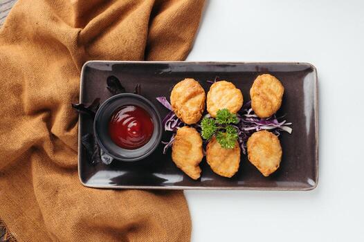 Crispy Fried Chicken Nuggets with Red Sauce and Cabbage photo