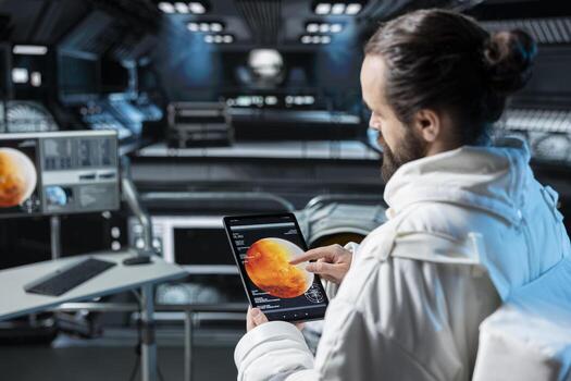 Astronaut using tablet to confirm suit integrity during journey to Mars. Orbital station crew member testing gear during routine equipment check during trip to red planet photo