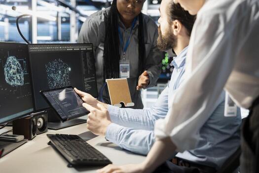 Engineering team doing brainstorming in data center, using AI powered tech to run simulations. Teamworking colleagues coding algorithms to extract insights from data and automate rigs photo