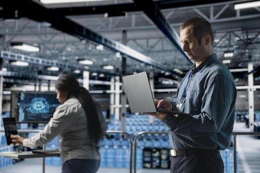 Server farm team of technicians debugging machine learning scripts on laptop, doing AI automatization. Data center programmer and coworker optimizing neural networks, adjusting deep learning models photo