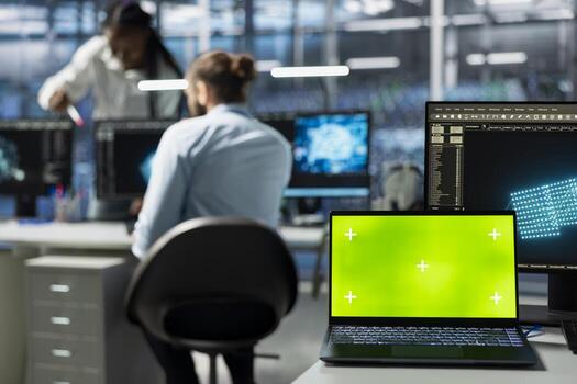 Close up of green screen mockup laptop in data center used by engineers doing troubleshooting. Chroma key isolated screen notebook in server hub used by workers auditing systems photo