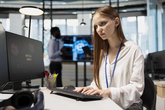 Female technician seeing critical error warning popup while adjusting deep learning algorithms parameters at work. Young worker receiving glitch failure alert while working with AI photo