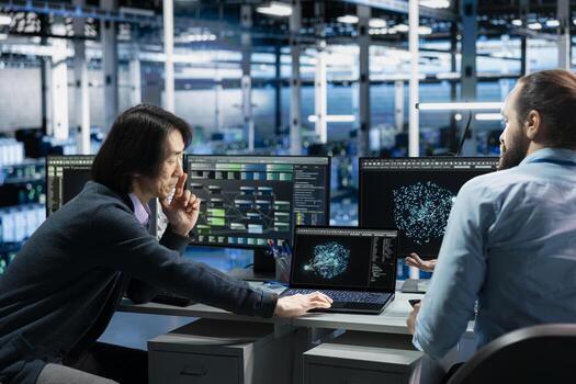 Software developers in data center troubleshooting server connectivity issues using AI. Asian man and technician in server room auditing systems for vulnerabilities using artificial intelligence photo
