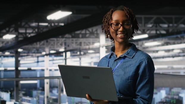 Portrait of joyful computer scientist in data center monitoring neural network LLM visualization. Upbeat woman in server farm overseeing rigs powering machine learning processes photo