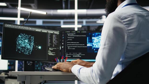 Data center computer scientist at desk using AI deep learning algorithms to analyze datasets. Server room IT specialist typing on PC keyboard, using artificial intelligence neural networks, camera A photo
