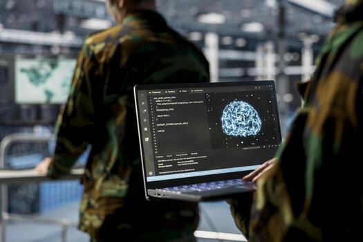 Close up of server hub employee in soldier uniform using laptop, running AI tools. Army information technology specialist in data center deploying machine learning models for battlefield analytics photo