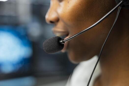 Extreme close up of headset microphone used by admin in data center to provide user technical support. Server hub worker talking in mic, assisting clients during remote call photo