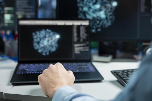 Close up of data center developer using laptop, monitoring AI systems, adjusting machine learning parameters. Server room IT professional using notebook, enhancing artificial intelligence performance photo