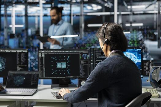 Admin in data center speaks in headset mic, troubleshooting rigs connectivity issues using AI. IT expert doing tech support in server hub, talking in remote call, auditing systems for vulnerabilities photo