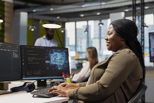 Jolly programmer at work training machine learning models for anomaly detection automation. Upbeat tech startup employee using artificial intelligence to monitor network issues photo