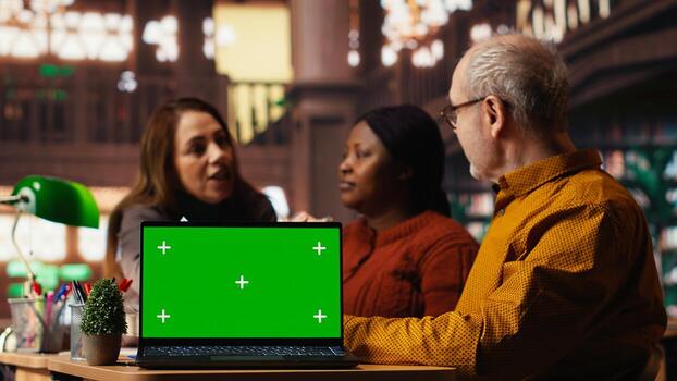 Colleagues practicing script reading in a public library with mockup, engaged in drama rehearsal and character development. Cast members preparing for classic theatre performance. photo