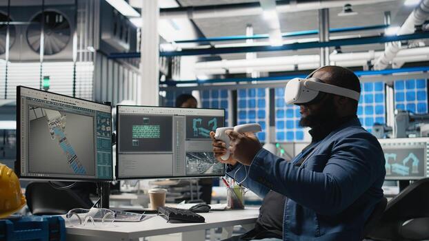 Black photovoltaics factory expert uses VR glasses to assembly digital solar cells, working with robotic arms for solar panels placement. Engineer uses machinery with virtual reality. Camera A. photo