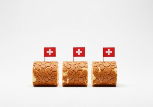 Three swiss flag adorned bread rolls against a white background photo