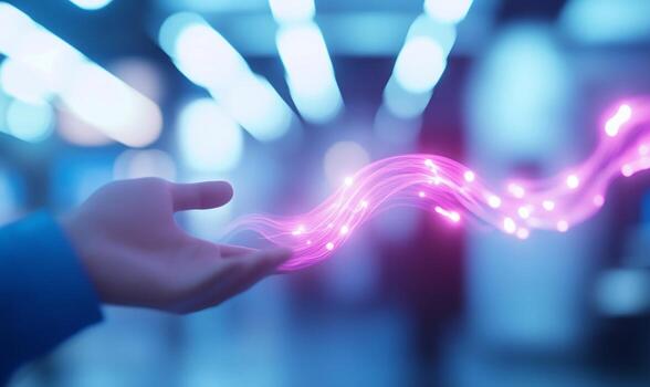 A glowing digital line streams from a hand, representing innovation, connection, and data flow photo