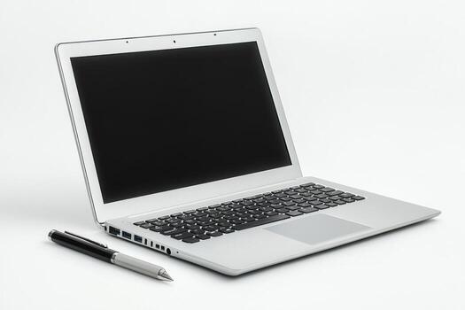 A laptop computer and pen on a white background photo