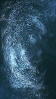 Abstract liquid motion effect vertical background with a vortex of swirling blue water particles in fluid motion. Ideal for themes of energy, nature, or science projects. video