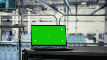 Green screen laptop in server hub with hardware supporting AI driven services. Mockup notebook in data center storing and processing vast datasets for artificial intelligence operations video