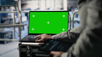 dati centro tecnico monitor in profondità apprendimento processi con verde schermo computer portatile, rivedere operativo metrica. Admin utilizzando modello taccuino per revisione neurale reti rapporti durante ispezione, telecamera B video