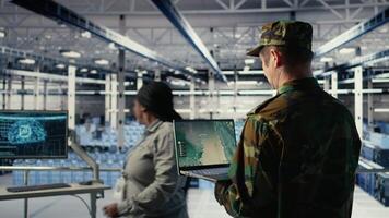 Military data center expert using ballistic missiles radar on laptop to watch for enemy threats. Army soldier in data center uses scanner tech to detect rockets launched by enemy troops, camera A video