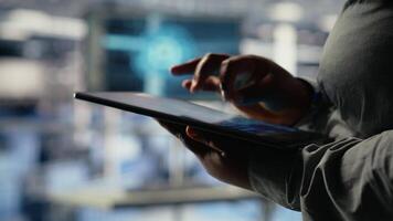 Data center programmers check AI dashboard using tablet, doing systems review. Server hub coworkers test artificial intelligence tools on device to ensure reliable performance, camera B video