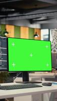 Vertical Stock market metrics charts displayed on green screen computer display in investment firm office. Workstation in forex company workspace with live financial data visible on chroma key PC video