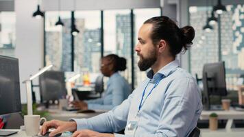 Close up of happy trader in prop firm workplace analyzing market data and executing trades using trading software interface on PC. Joyous stockbroker at work monitoring stock prices, camera B video