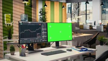 Stock market metrics visualization displayed on green screen PC in proprietary firm office. Desktop setup in forex company workspace with financial statistics visible on mockup computer video