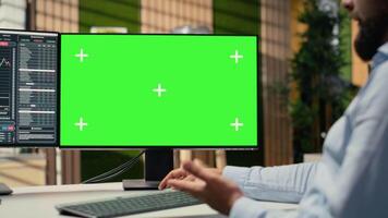 Close up of investment consultant using green screen PC to review client portfolio in office. Trader assisting customers, providing tailored financial strategy using chroma key computer video